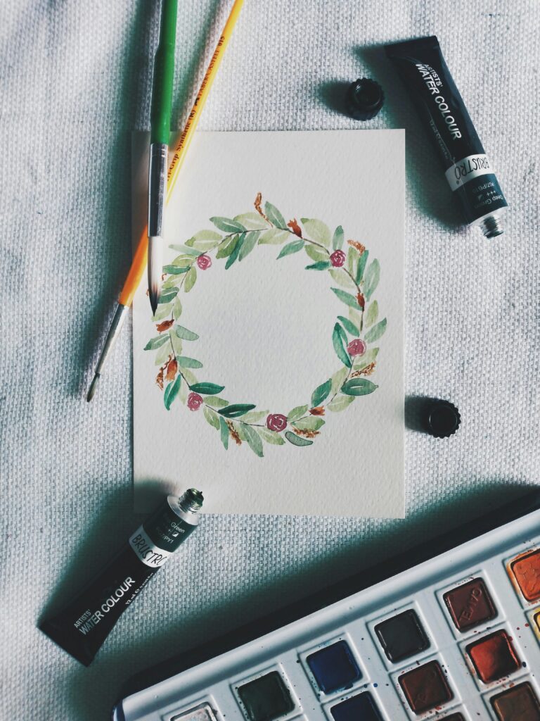 pexels photo 5152829 5152829 Floral watercolor art with paint tubes and brushes on white cloth.