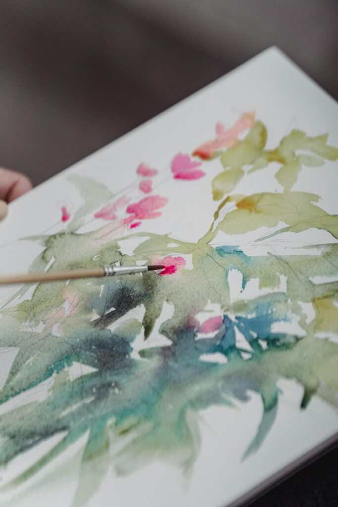 pexels photo 7859199 7859199 Vibrant watercolor painting in progress on a sketchbook with brush.